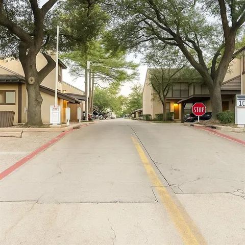 a living room with furniture gym equipment and large windows