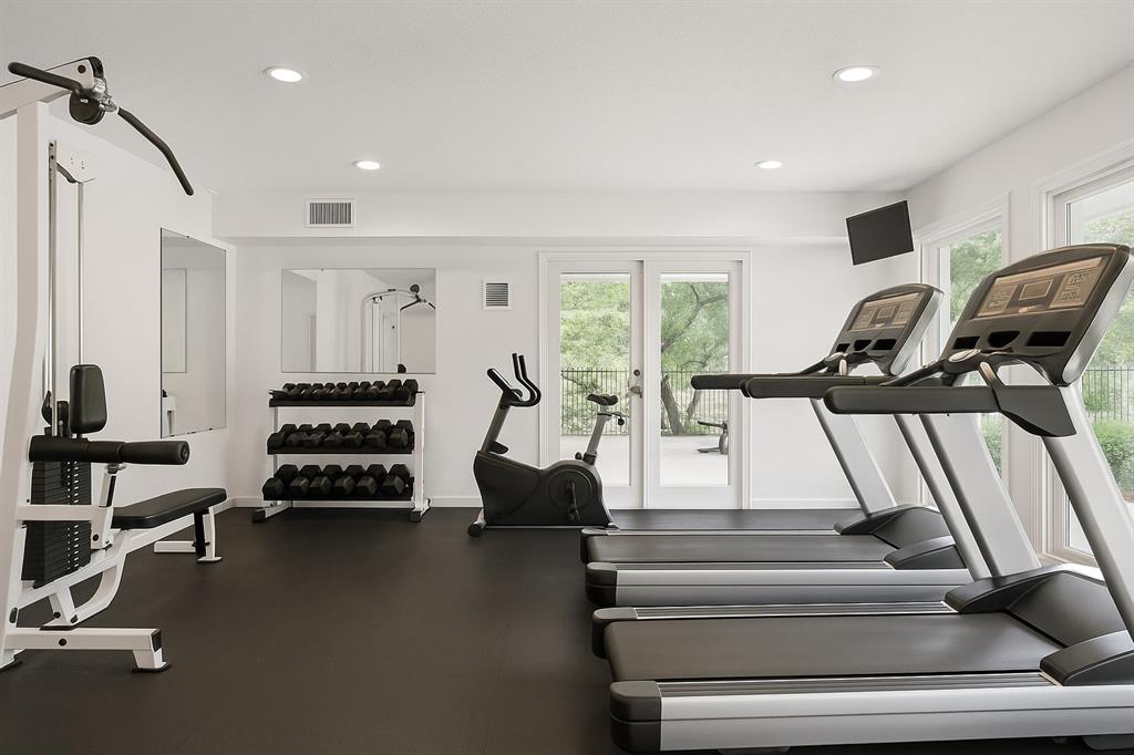 4561 O North O'Connor Road, Unit 1294 Irving, TX 75062 - Photo 28 of 31 a living room with furniture gym equipment and large windows