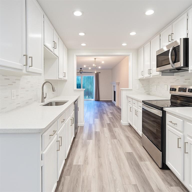 4561 O North O'Connor Road, Unit 1294 Irving, TX 75062 - Photo 4 of 31 a large kitchen with stainless steel appliances granite countertop a lot of counter space and wooden floor