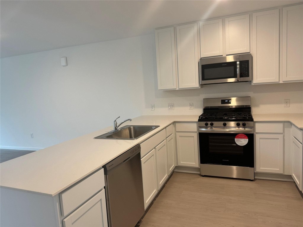 26710 Feather Reed Drive Katy, TX 77493 - Photo 5 of 10 a kitchen with a sink and a stove top oven