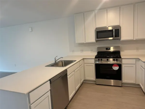 a kitchen with a sink and a refrigerator
