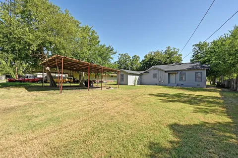 a house view with swimming pool in front of it