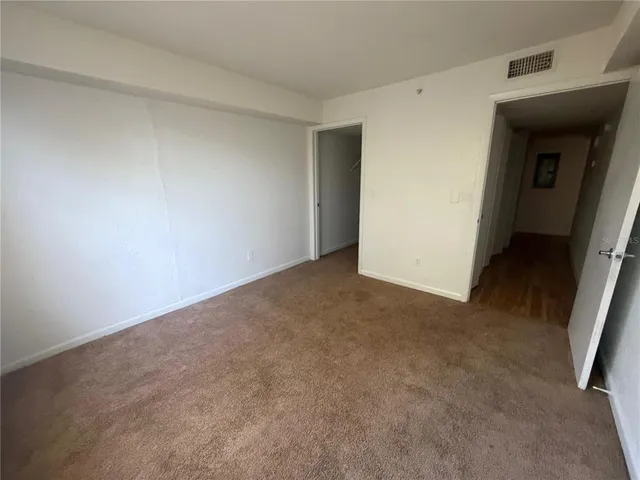 a view of an empty room and closet
