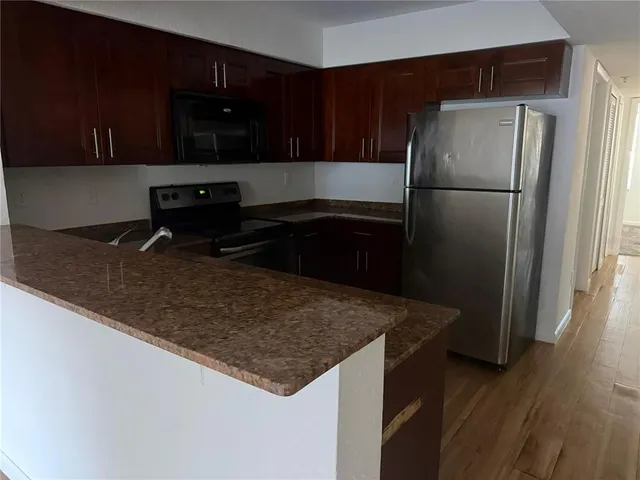 a kitchen with a refrigerator and a sink