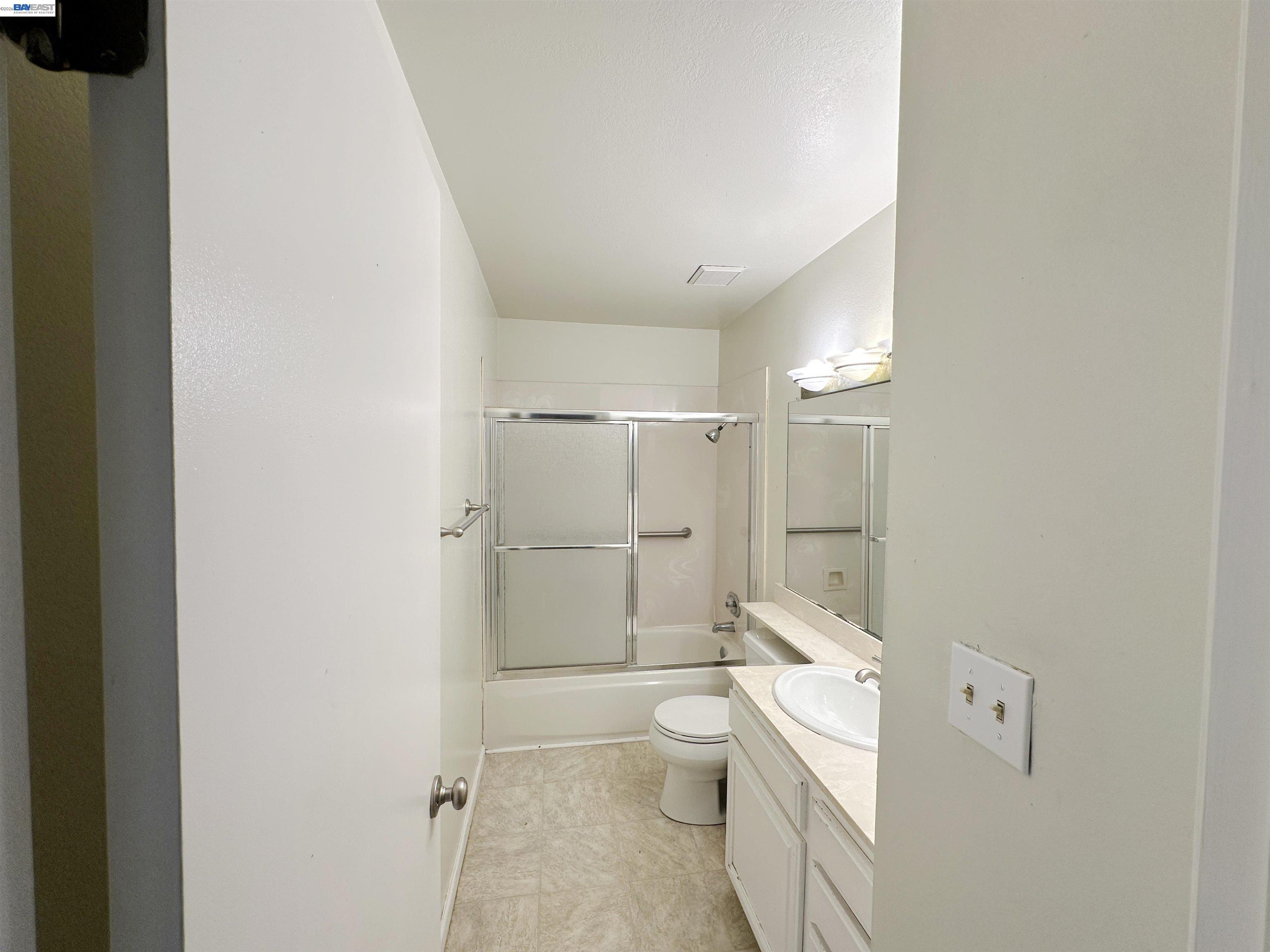 4565 Wildcat Lane Concord, CA 94521 - Photo 13 of 15 a bathroom with a granite countertop toilet sink and shower