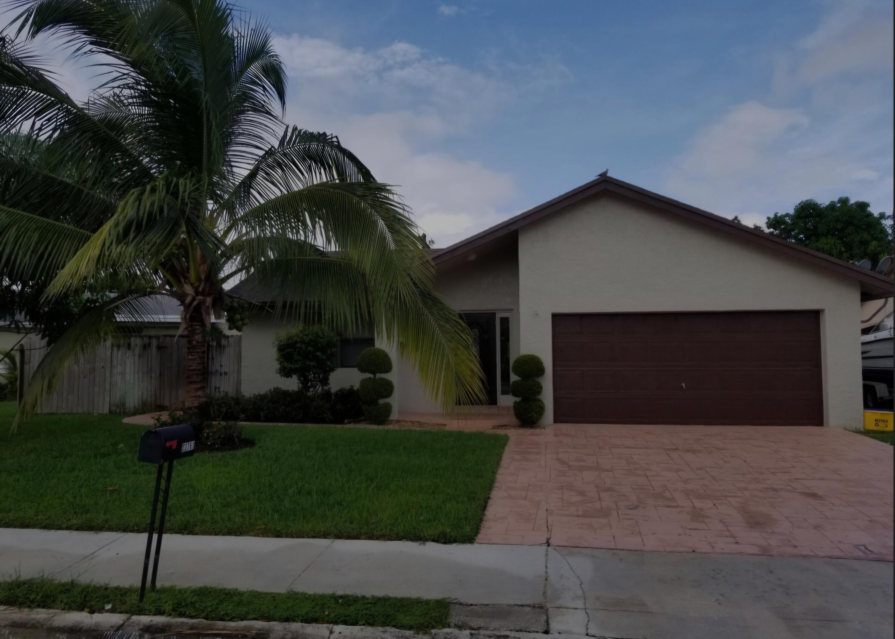 a front view of a house with a yard and a garage
