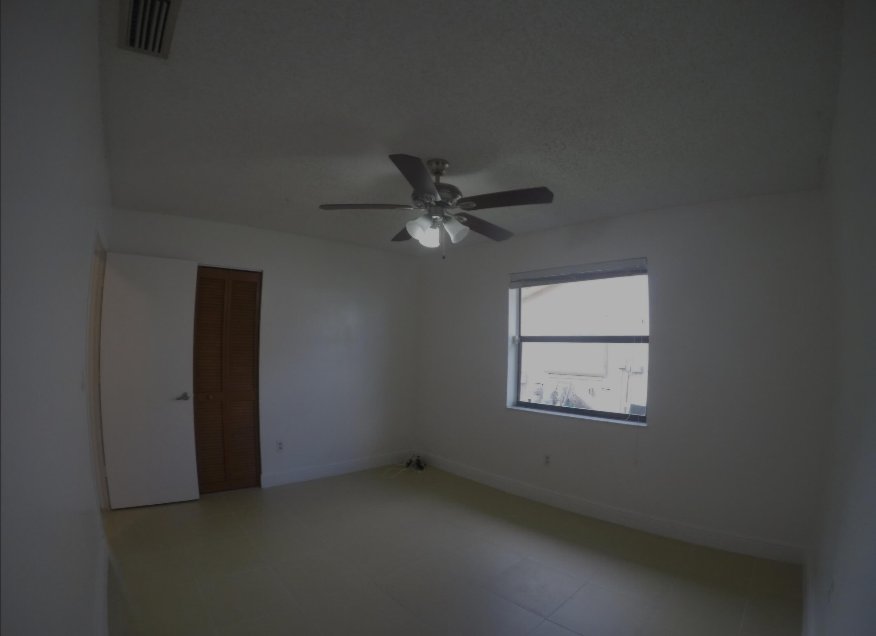 22761 Southwest 64th Way Boca Raton, FL 33428 - Photo 18 of 22 an empty room with a window and a fan