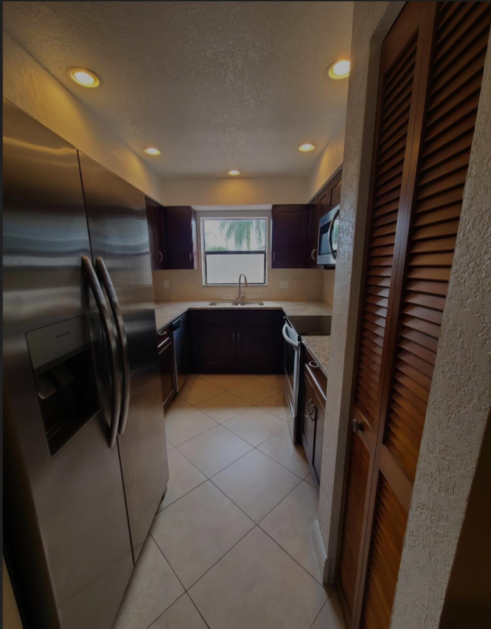 22761 Southwest 64th Way Boca Raton, FL 33428 - Photo 20 of 22 a kitchen with stainless steel appliances granite countertop a refrigerator and a sink