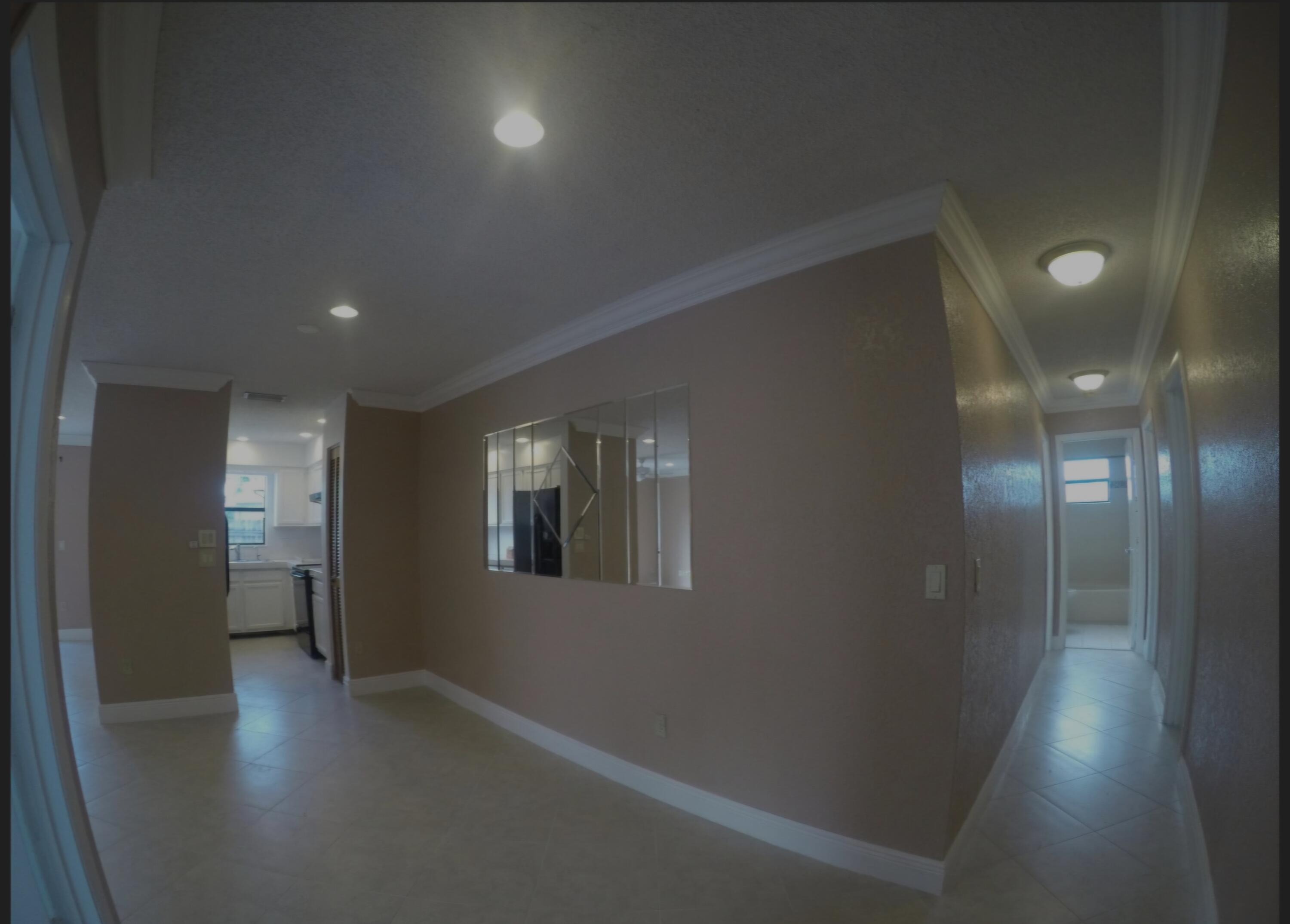 22761 Southwest 64th Way Boca Raton, FL 33428 - Photo 21 of 22 an empty room with wooden floor and windows
