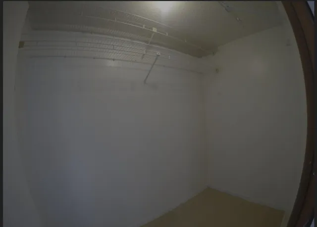 an empty room with a empty space and a window