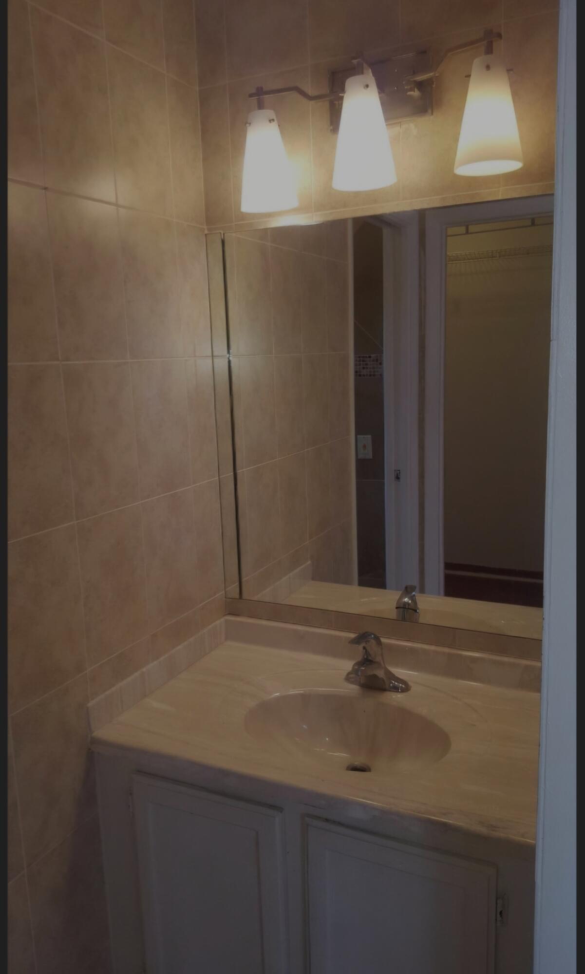 22761 Southwest 64th Way Boca Raton, FL 33428 - Photo 9 of 22 a bathroom with a sink and a mirror