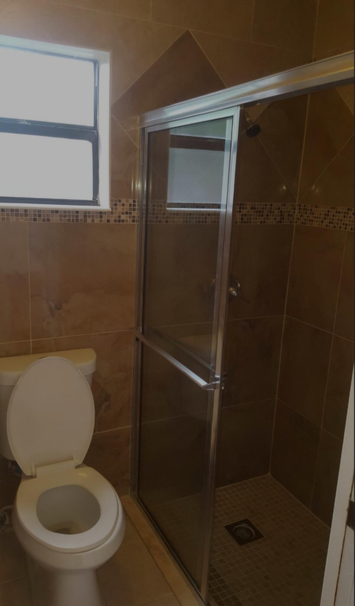 22761 Southwest 64th Way Boca Raton, FL 33428 - Photo 10 of 22 a bathroom with a toilet and a shower