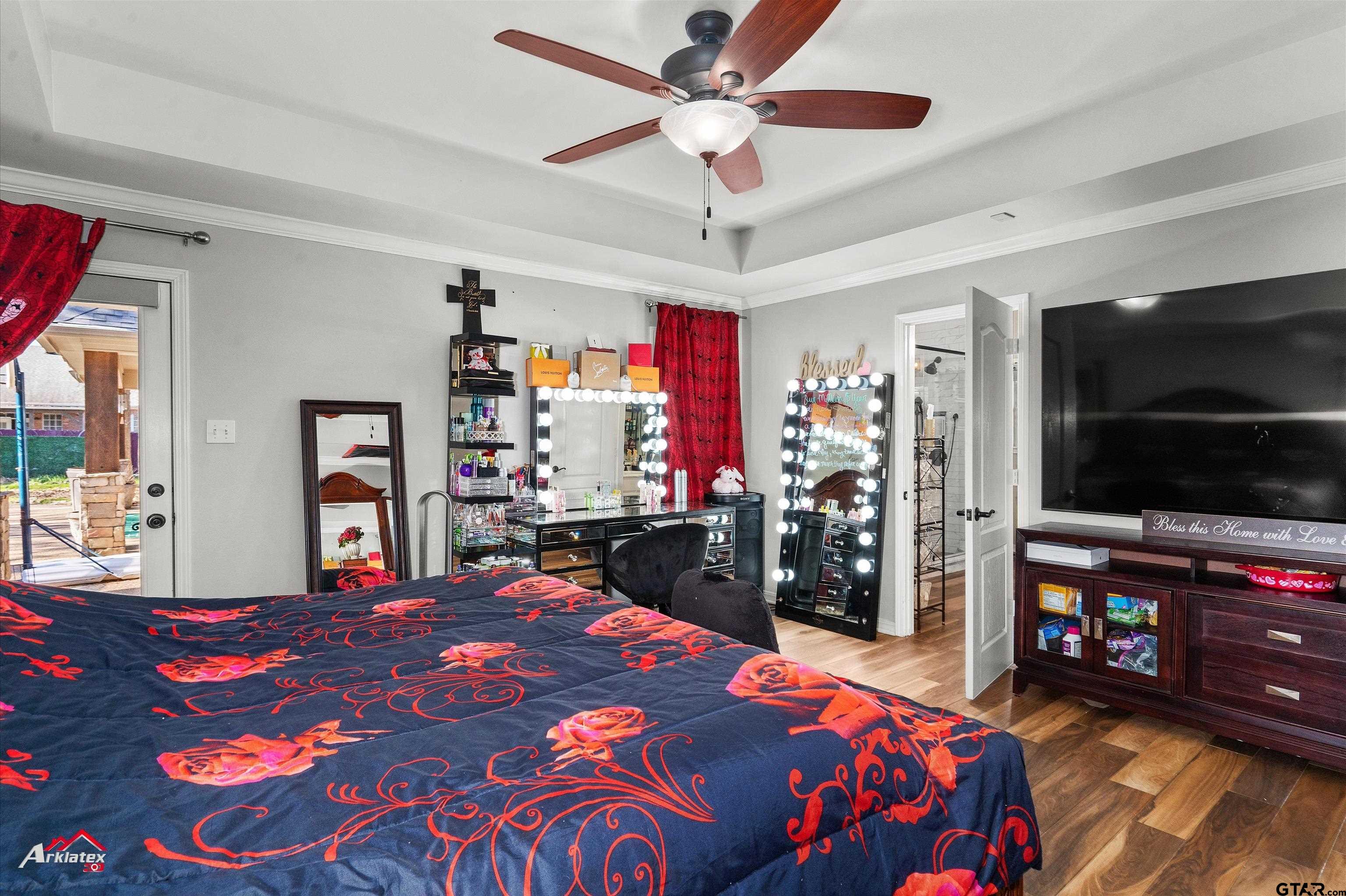 3815 Holly Ridge Drive Longview, TX 75605 - Photo 13 of 22 a bedroom with a bed and a flat screen tv