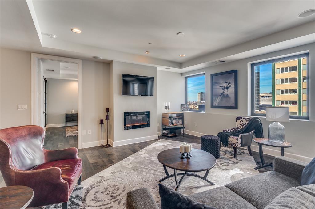 1505 Elm Street, Unit 1504 Dallas, TX 75201 - Photo 10 of 33 a living room with furniture fireplace and a large window