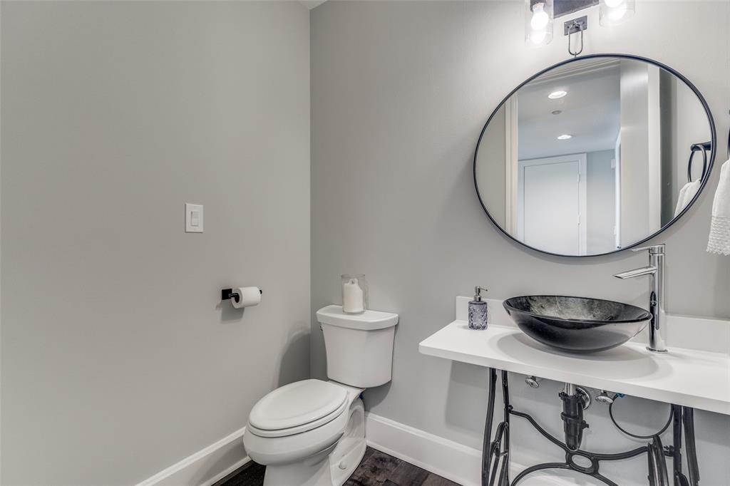 1505 Elm Street, Unit 1504 Dallas, TX 75201 - Photo 13 of 33 a bathroom with a toilet a sink and mirror