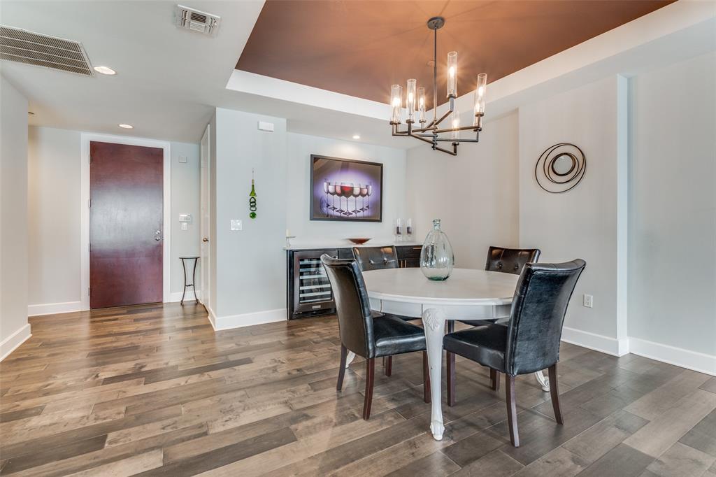 1505 Elm Street, Unit 1504 Dallas, TX 75201 - Photo 2 of 33 a view of a dining room with furniture a chandelier and wooden floor