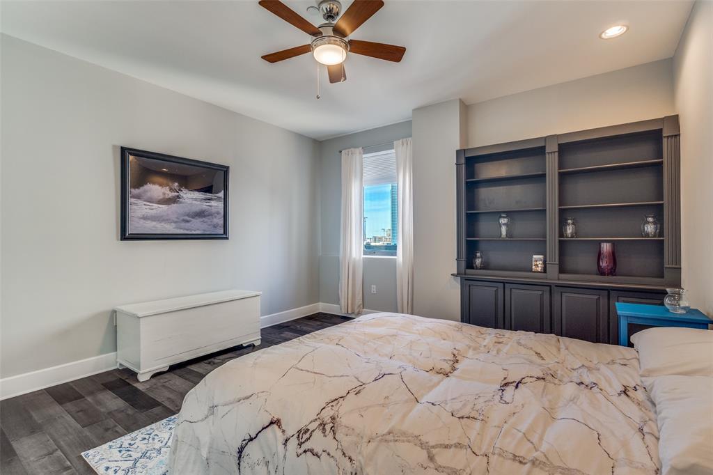 1505 Elm Street, Unit 1504 Dallas, TX 75201 - Photo 22 of 33 a bedroom with a bed and a chandelier