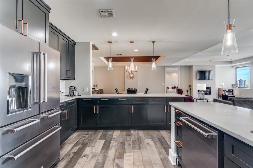 1505 Elm Street, Unit 1504 Dallas, TX 75201 - Photo 6 of 33 a large kitchen with a sink and stainless steel appliances