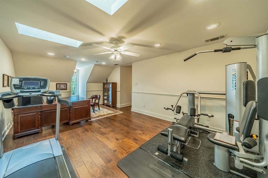 7451 County Road 1509 Athens, TX 75751 - Photo 20 of 36 a view of a kitchen with kitchen island a counter top space appliances and a ceiling fan