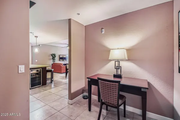 a room with a table chairs and a lamp