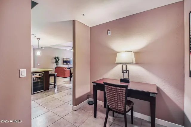 a room with a table chairs and a lamp