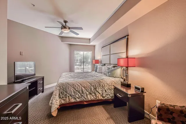 a bedroom with a bed and a flat tv screen