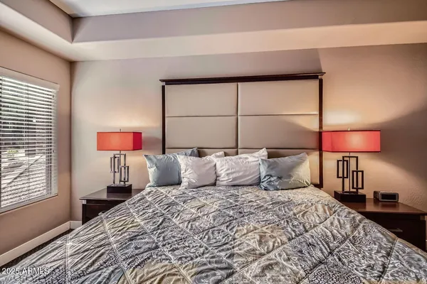 a bedroom with a bed and a lamp