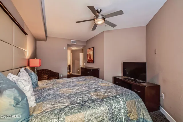 a bedroom with a bed and a flat screen tv