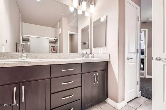 a bathroom with a sink vanity and a mirror