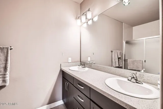 a bathroom with a double vanity sink and a mirror