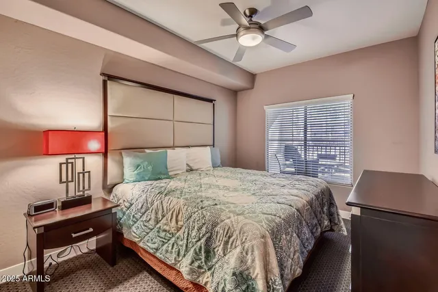 a bedroom with a large bed and a desk