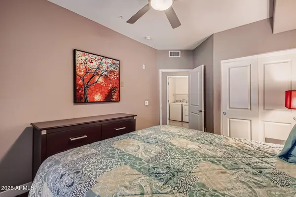 a bedroom with a bed and a chandelier