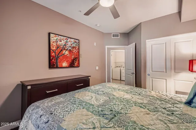 a bedroom with a bed and a chandelier