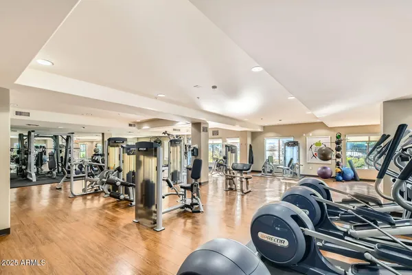 a gym room that has a lot of gym equipment