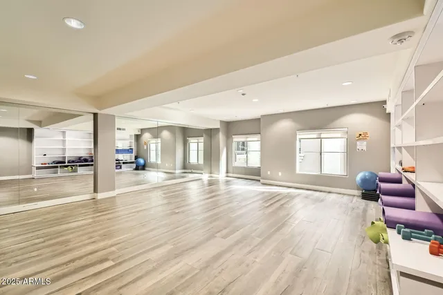 a big room with wooden floor and windows