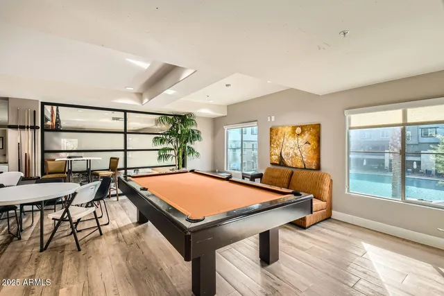 a room with pool table and windows