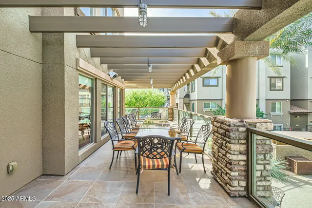a view of an outside dining space with furniture window and outside view