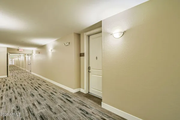 a view of a hallway with wooden floor