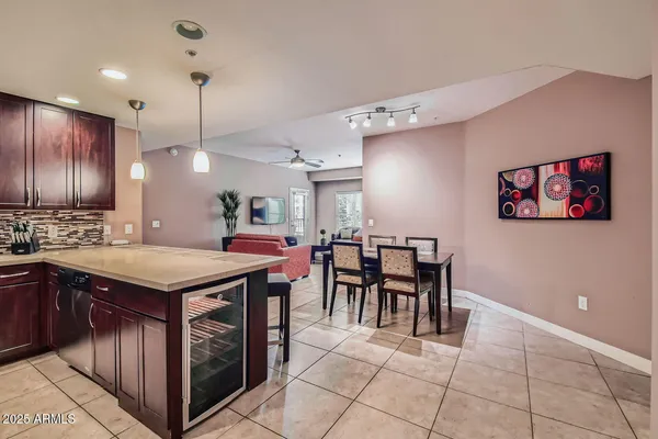 a kitchen with a stove a refrigerator a sink dishwasher with a dining table and chairs