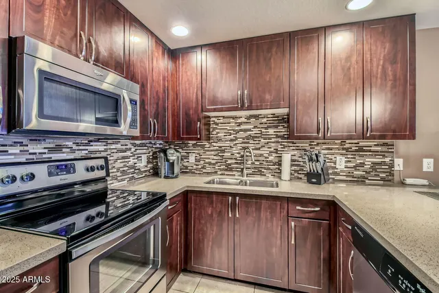 a kitchen with wooden cabinets and a stove top oven