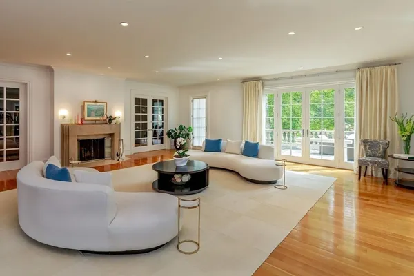 a living room with fireplace furniture and a large window