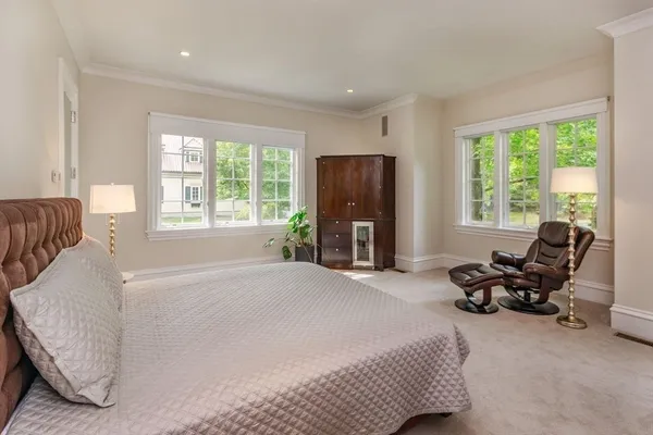 a bedroom with furniture and a large window