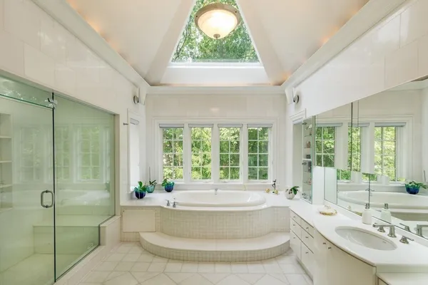 a spacious bathroom with a tub and sink