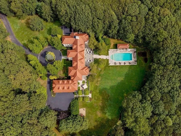 an aerial view of a house with a yard