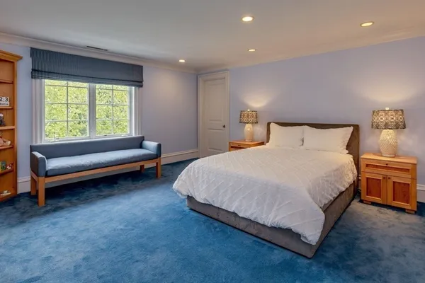 a spacious bedroom with a bed and a couch
