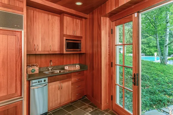 a kitchen with stainless steel appliances granite countertop a stove and a microwave