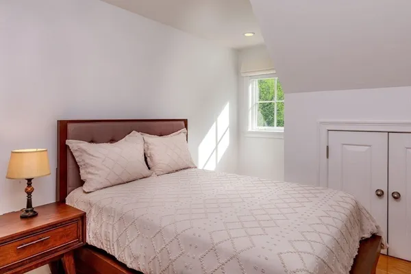 a bedroom with a bed and a lamp