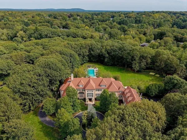 an aerial view of a house with a yard