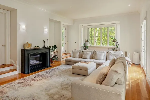 a living room with furniture a window and a fireplace