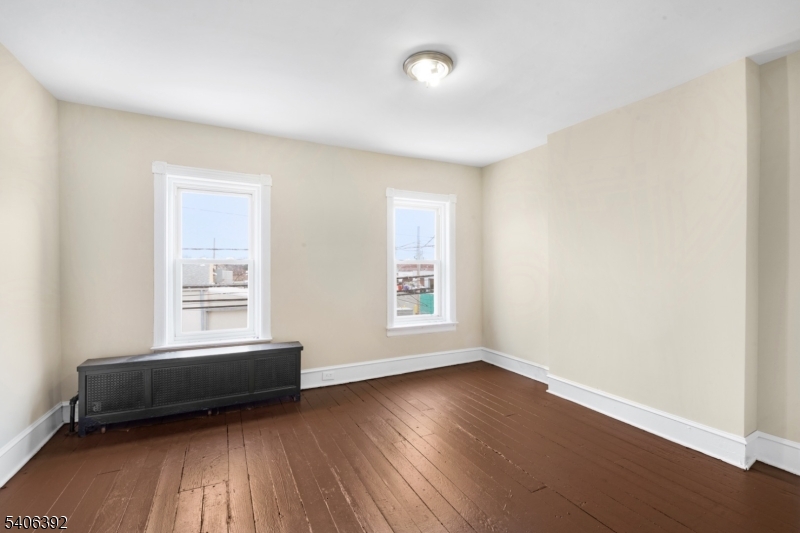 21 Short Street Trenton, NJ 08618 - Photo 12 of 22 an empty room with wooden floor and windows